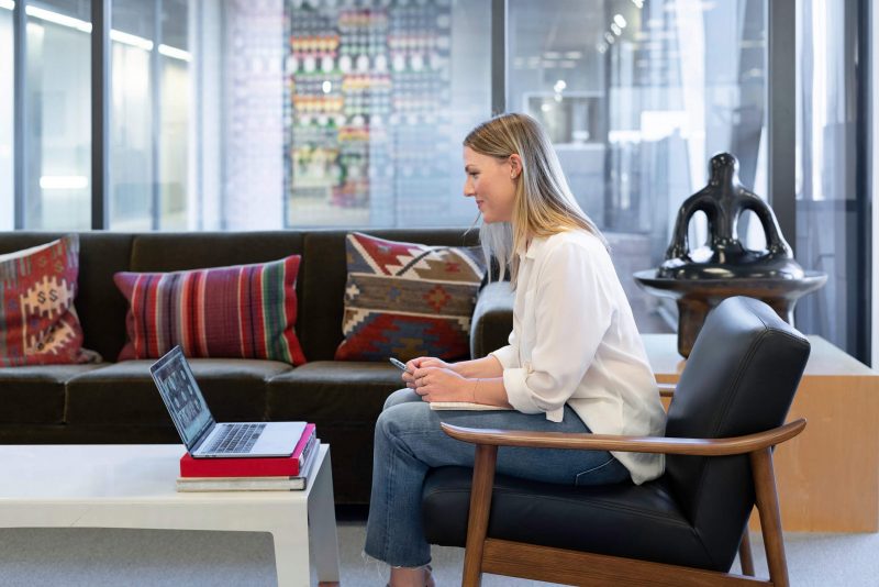 A woman attending a virtual meeting on a laptop